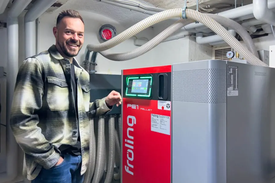 Kunde neben seiner neuen Fröling-Pelletheizung